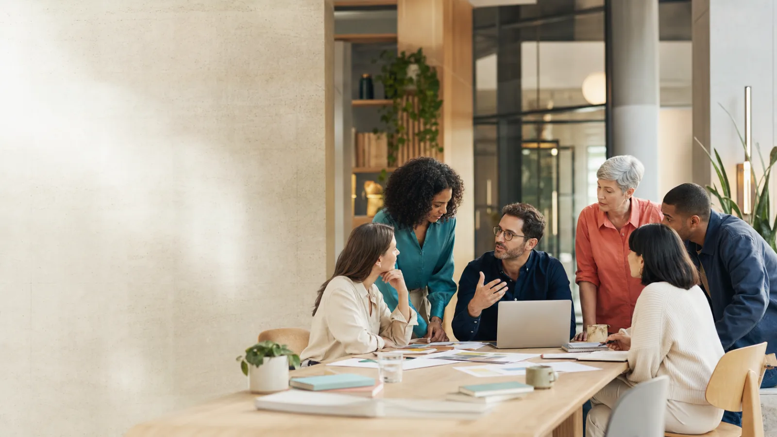 A group of colleagues discussing work around a table