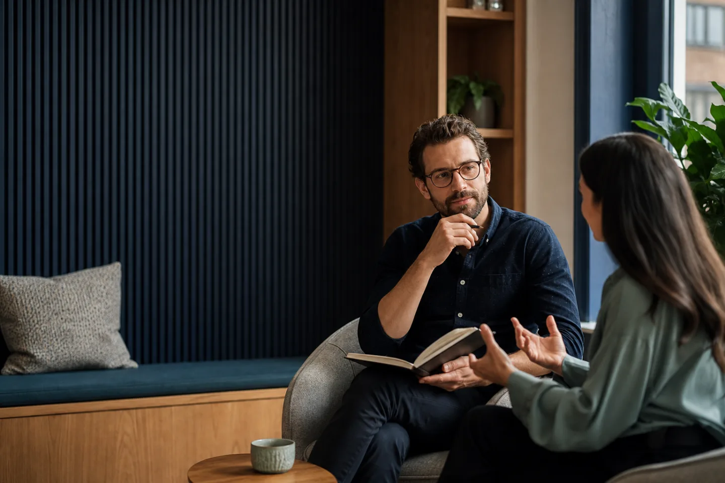 A manager listening to a colleague during a private workplace conversation